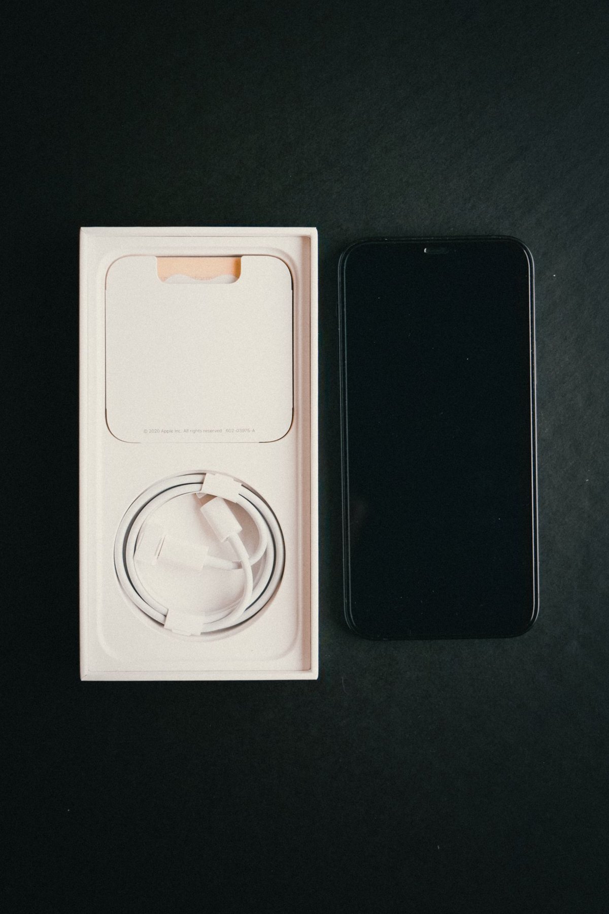 Phone beside its open box and coiled cable