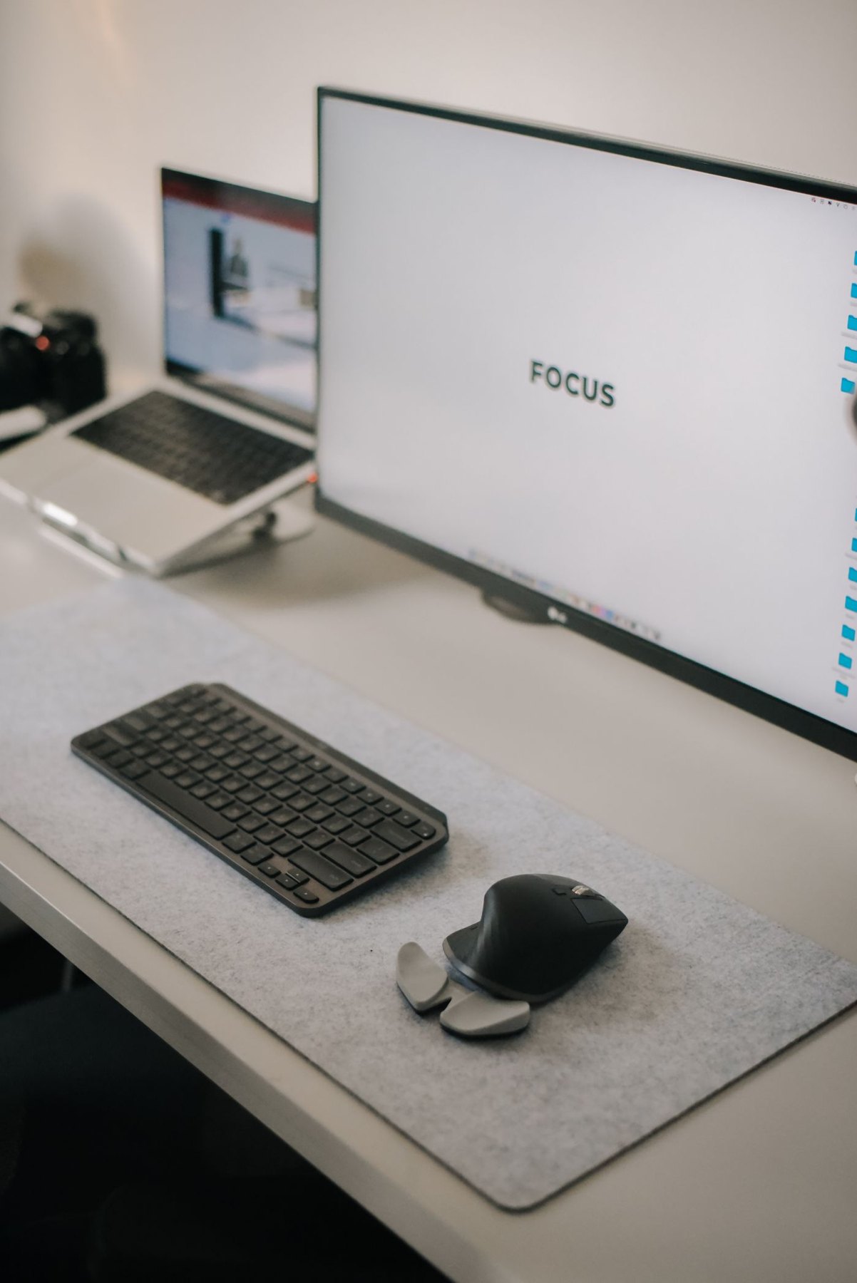 Laptop raised beside a separate monitor