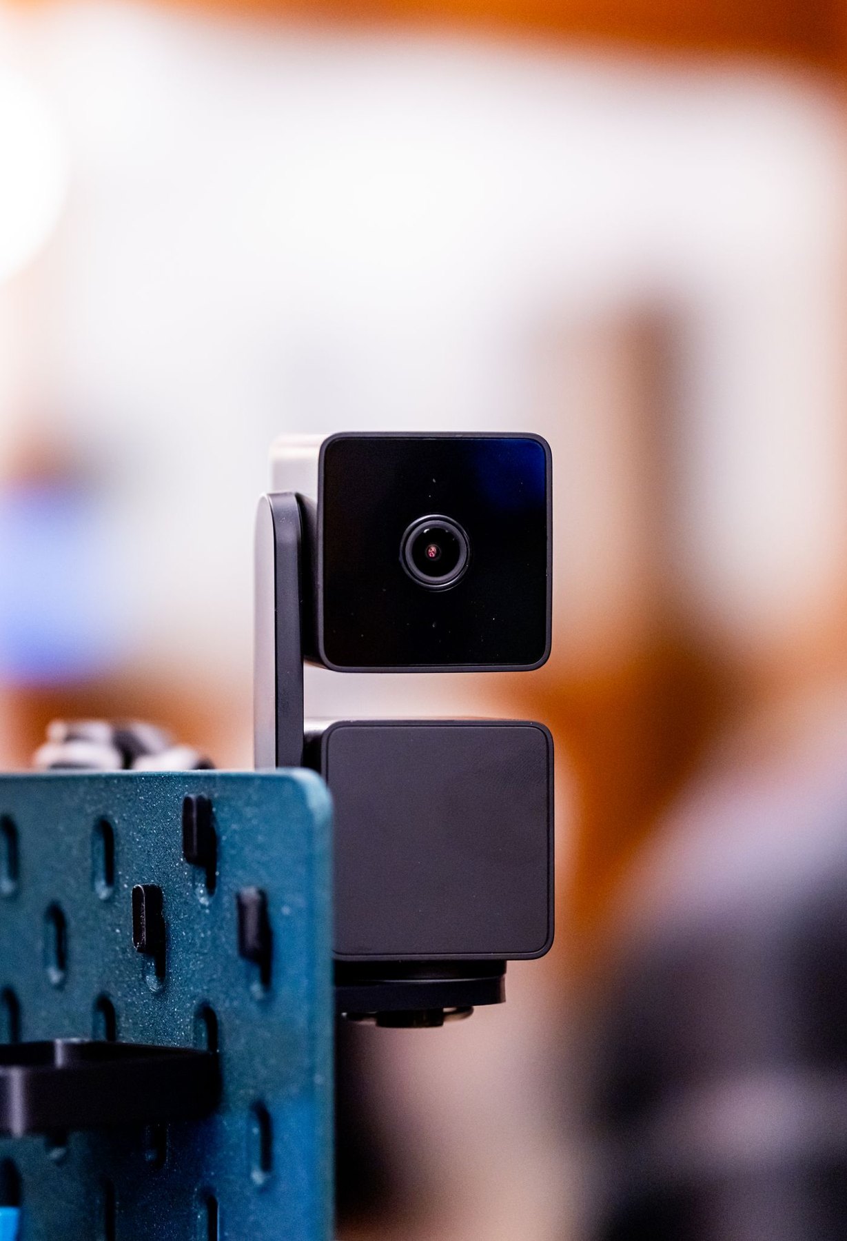 Small webcam standing on a support indoors