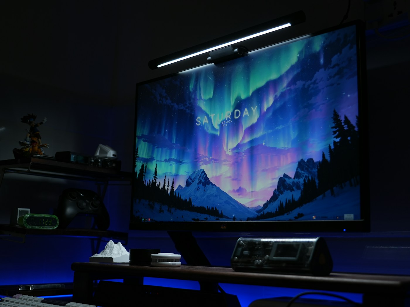 Monitor light bar mounted above a desktop display