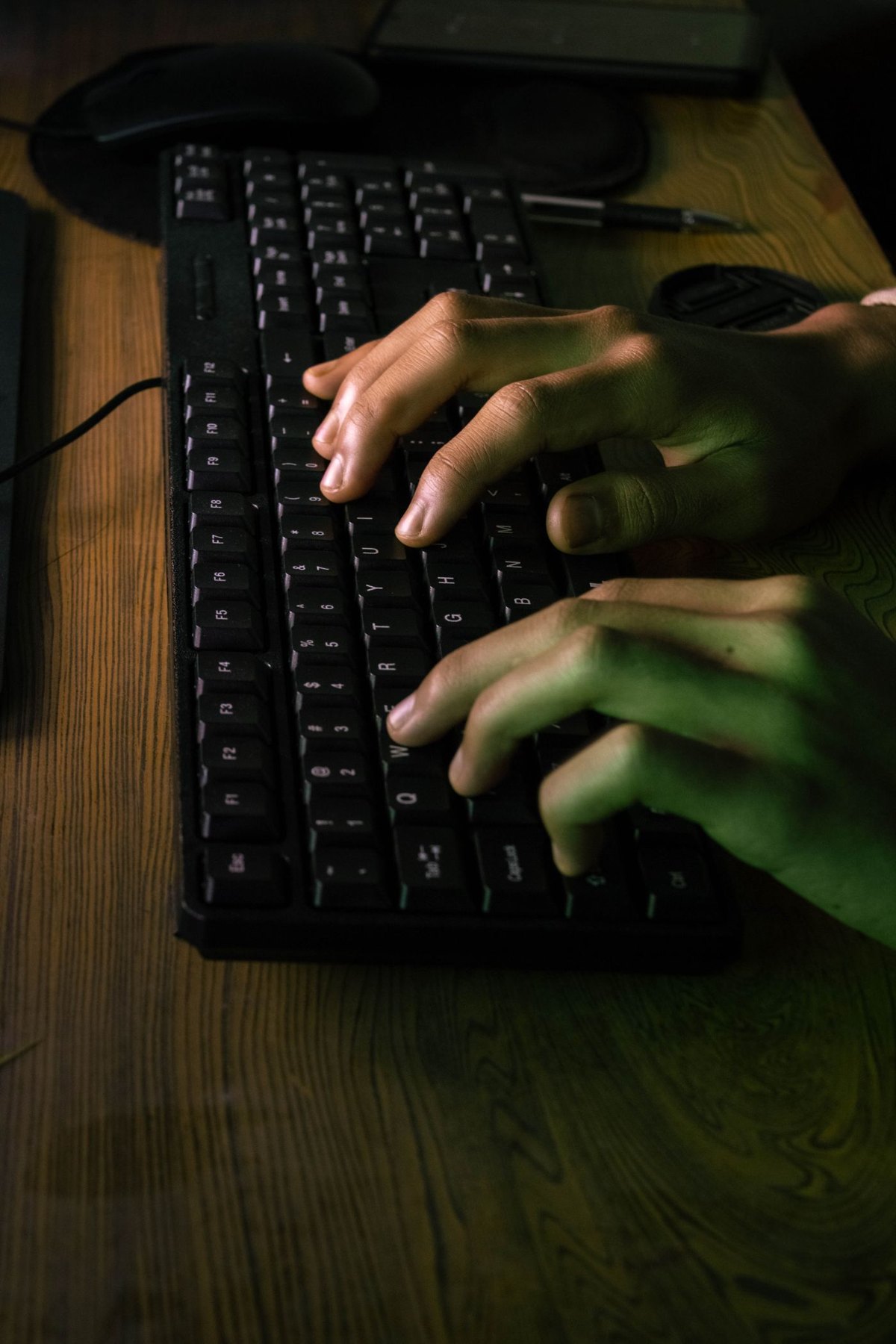 Hands typing on an external keyboard