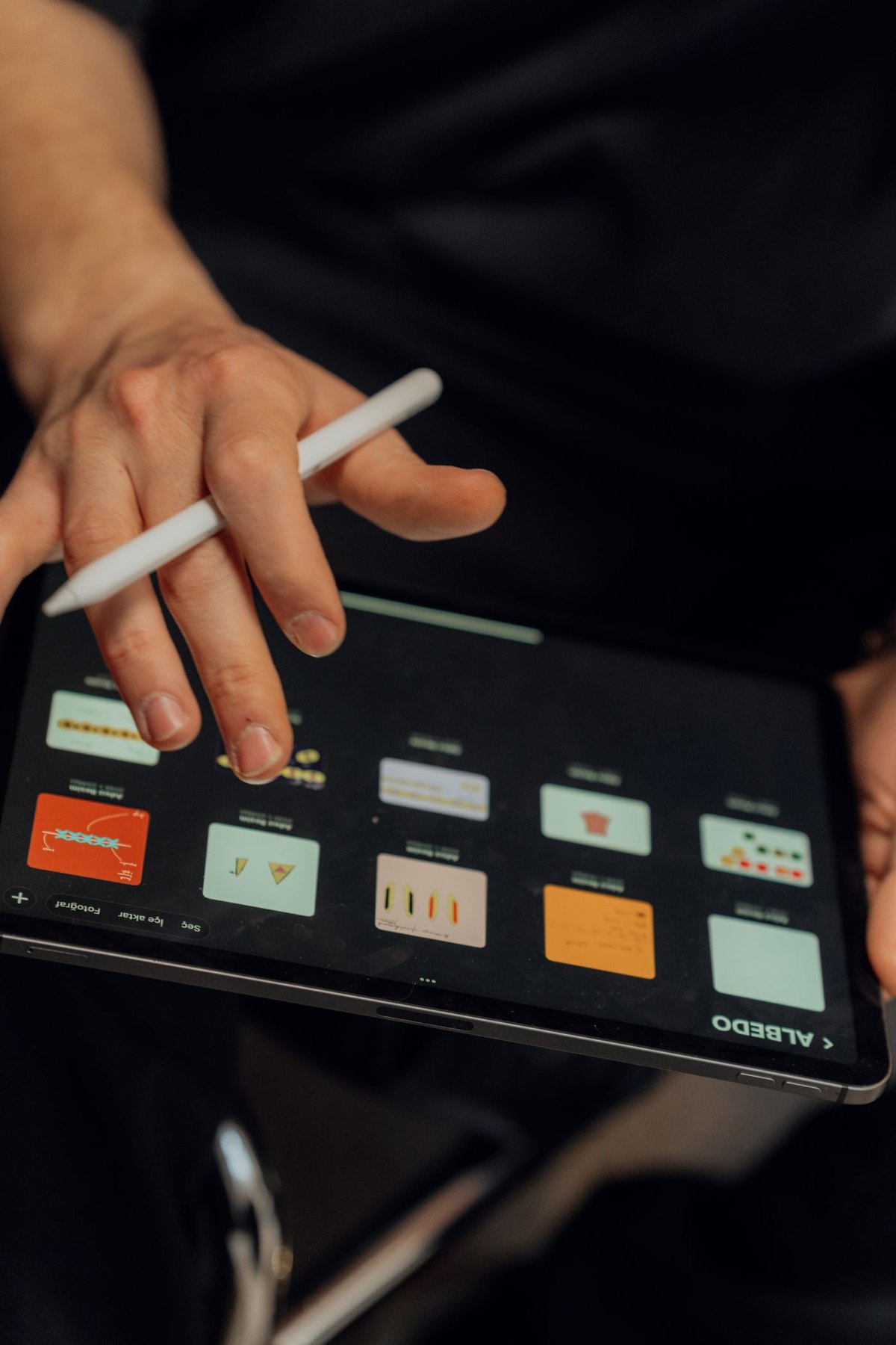 Person working with a stylus on a digital tablet