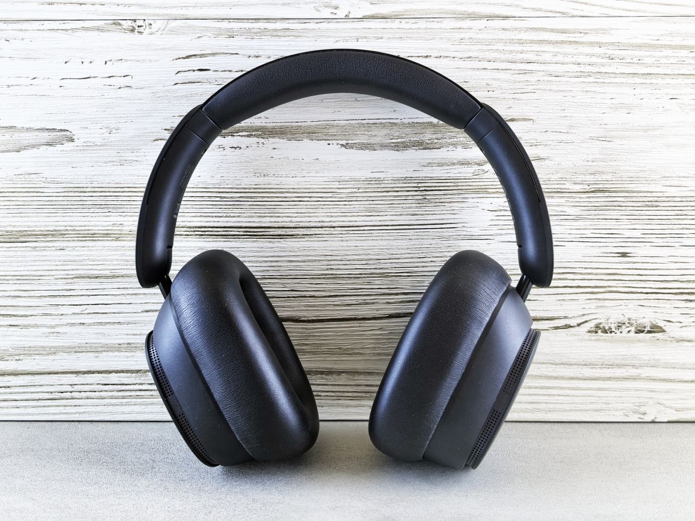 Padded over-ear headphones on a wood surface