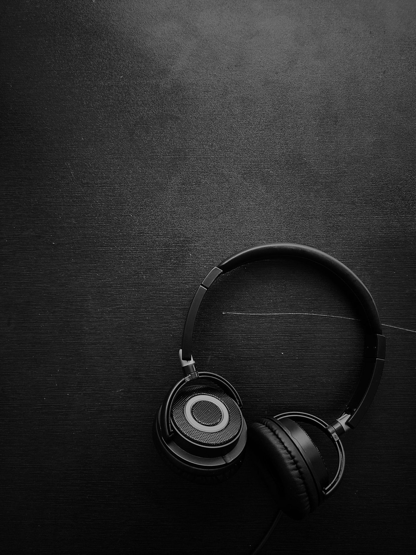 Over-ear headphones against a dark background