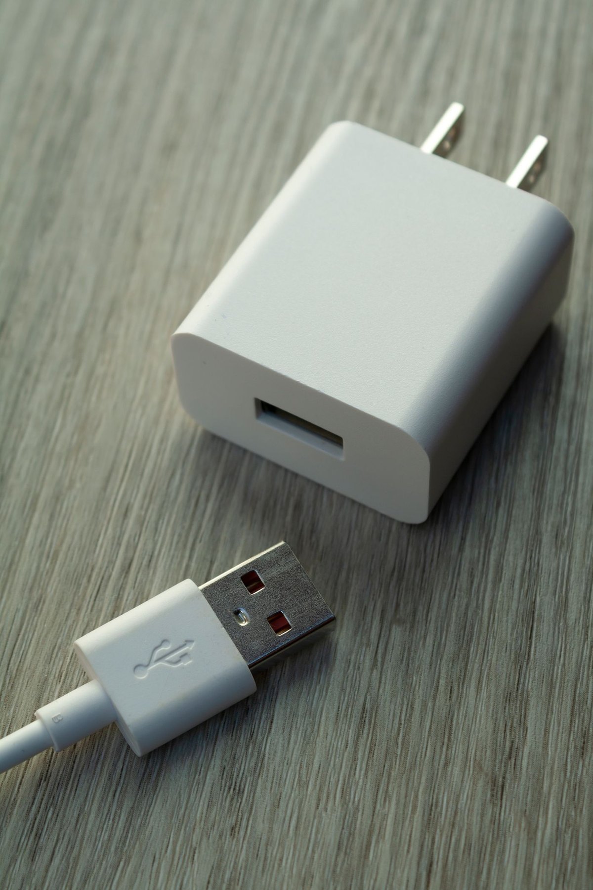 USB power adapter and disconnected cable on a desk