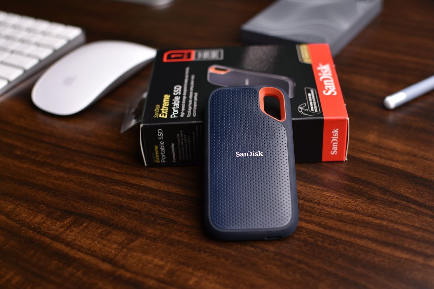 Portable solid-state drive beside its box on a desk