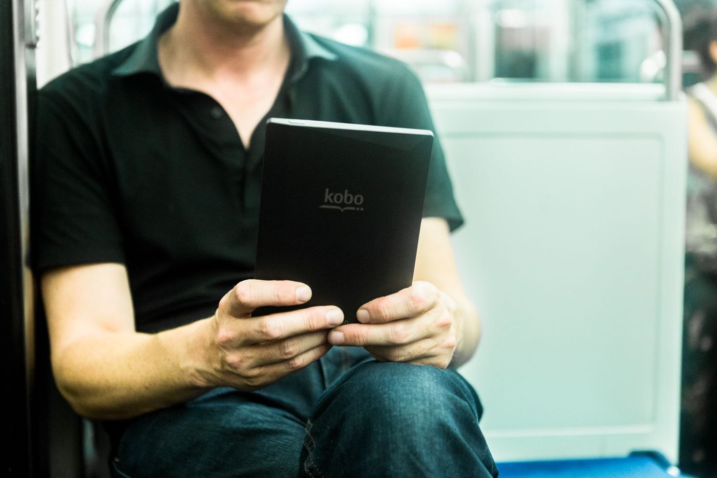 Person holding a black e-reader