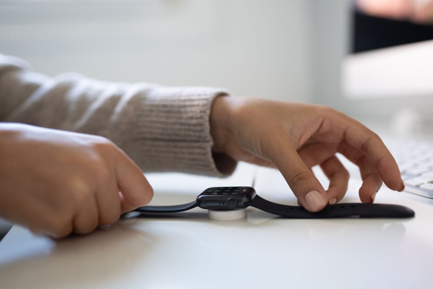 Hands adjusting the strap of a smartwatch