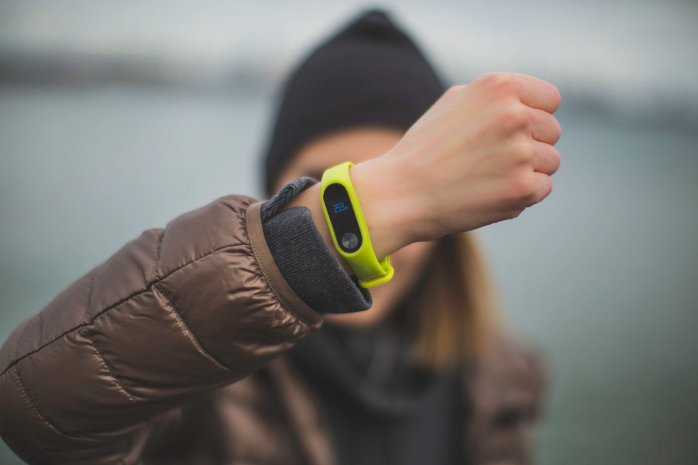 Green fitness band on a wrist
