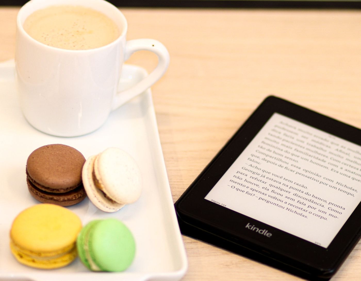 E-reader with a page of text beside coffee